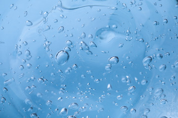 Sample of light blue cosmetic gel as background, closeup