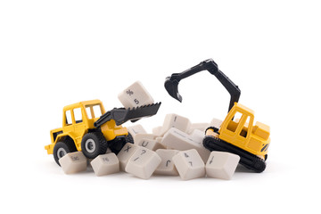 Bulldozer and excavator working on computer keys isolated on white background with clipping path....