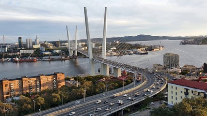 Golden bridge in Vladivostok across The Golden horn Bay. The photo was taken in September 2019. In the background, you can see the bridge to Russian island.