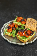 Vertical shot of a plate with delicious vegan avocado sandwiches
