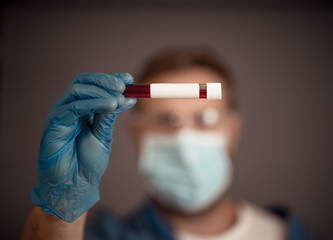 Scientist testing coronavirus positive blood sample researching for COVID-19 antibodies and vaccine