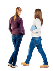 Back view of two woman in sweater.