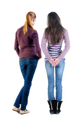 Back view of two woman in sweater.