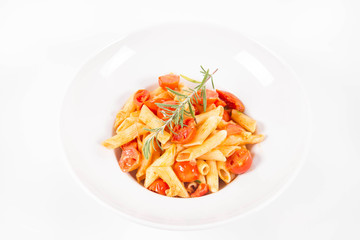 Penne with tomatoes, garlic and mozzarella decorated with rosemary twig, on a white background