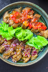 eggplant salad spices and tomatoes, antipasto Menu concept healthy eating. food background top view copy space for text keto or paleo organic product diet
healthy eating