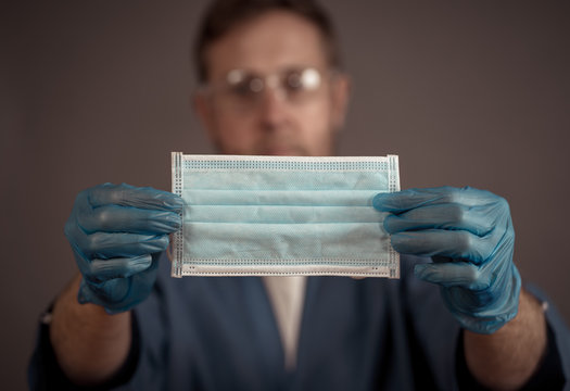 COVID-19 Stop the virus Spread, Doctor showing face mask PPE in protect yourself and others concept.