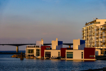 Kalmar, Sweden A modern redeveloped neighborhood and houseboats by the sea called Varvsholmen and a view towards the Oland bridge. © Alexander