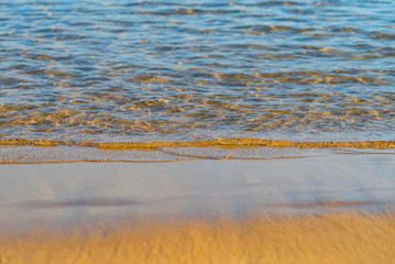 Waves closeup on Playa de Las Teresitas. Famous beach on the north of Tenerife island, near Santa Cruz. Only one beach with the golden sand from Sahara desert. Canary Islands, Spain