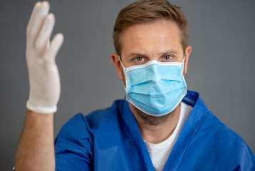Male Doctor or Nurse Wearing Protective face medical Mask. Save lives from Covid-19 Outbreak