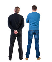 Back view of two man in sweater pointing.