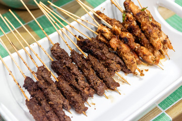 Chicken and beef skewers or meat on the grill Indonesian food satay