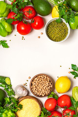 Obraz na płótnie Canvas Food background. Frame of various vegetables, chickpeas, mung bean and polenta on a white background, top view. Vegetarian and vegan food, arabic cuisine. Flat lay, copy space, banner. 