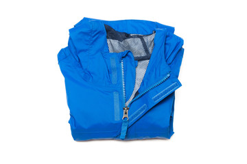 Folded blue zipper windbreaker jacket, rain proof and waterproof hiking Gore-Tex jacket hoodie. Track jacket sport nylon full zip isolated on white. Folded clothes. Outer layer garment for travel.