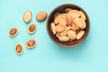 Homemade nuts with condensed milk, chocolate inside, walnuts and almonds. Nuts on a light blue background. A place for text.
