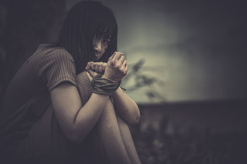 Asian hostage woman Bound with rope at night scene,The thieves kidnapped for ransom,thailand people