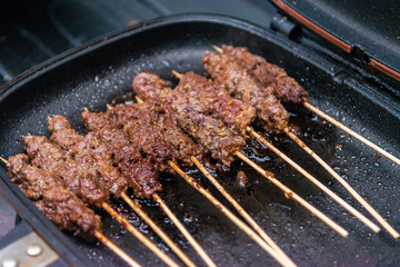Beef skewers or meat on the grill Indonesian food sate
