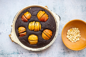 Baked brownie chocolate pie with whole apples. Vegan sweet dessert food.