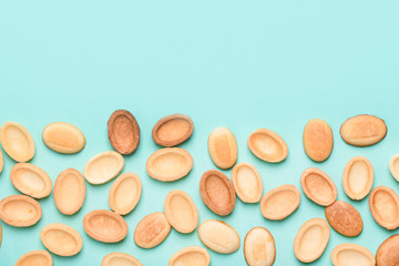 Homemade nuts with condensed milk, chocolate inside, walnuts and almonds. Nuts on a light blue background. A place for text.