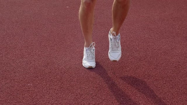 close up of an athlete running on a race track