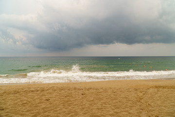 Storm clouds over a rough sea in Fujairah, UAE. Concept of bad weather, hurricane season and storm unstable times