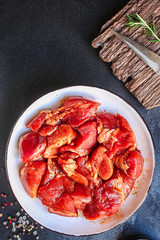 raw meat pork or beef in a plate on the table (preparing healthy food, marinade and spices paprika) menu concept background. top view. copy space for text
