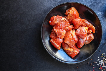 raw meat pork or beef in a plate on the table (preparing healthy food, marinade and spices paprika) menu concept background. top view. copy space for text