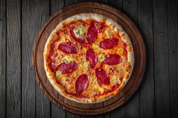 Tasty hot italian pizza with pepperoni sausages and dorblu cheese . Pizzeria menu. Concept poster for Restaurants or pizzerias