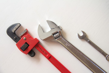 Male tools. close up Happy Father's Day inscription with Mechanic hand hold spanner tool on white background. Greetings and presents. white card with the ability to insert text, copyspace, 