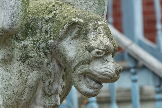 Old vintage Gargoyle statue in the form of a medieval winged monster.

