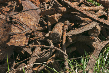 Ecology and recycling. Rusty scrap metal in a landfill in natural light. Details of cars, mechanisms.