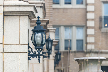 Decorative vintage old style street light Lanterns mounted on the building walls.