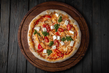 Tasty hot italian pizza Royal Prosciutto with Ham, Mushrooms, Cheddar Cheese, Oregano on old wooden table. Pizzeria menu. Concept poster for Restaurants or pizzerias