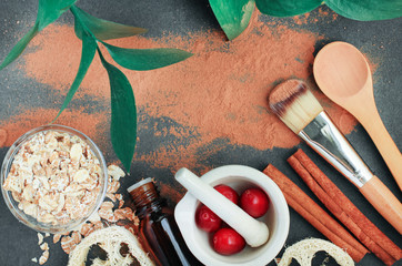 Top view ingredients homemade skin care clay facial mask with oatmeal, berries, cinnamon, on dark...