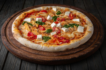 Tasty hot italian pizza Royal Prosciutto with Ham, Mushrooms, Cheddar Cheese, Oregano on old wooden table. Pizzeria menu. Concept poster for Restaurants or pizzerias