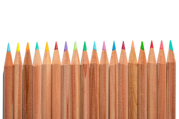 Wooden natural colored pencils isolated on white background flat lay. Copy space for text. Pastel drawing pen assortment. Stationary for art lessons, artist classes in kindergarten, school, college. 