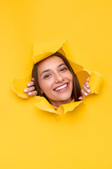 Happy woman ripping paper and smiling