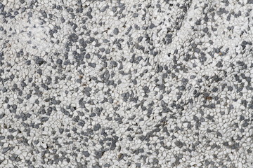 Concrete, plaster, wall covering, flooring made of small pebbles. Concrete made by mixing tiny black pebbles. Stone floor wall background brick pattern gray backdrop.