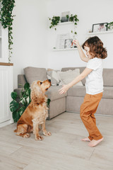 Cute little girl with dog at home