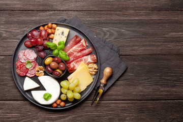 Cheese, meat, grapes and olives antipasto