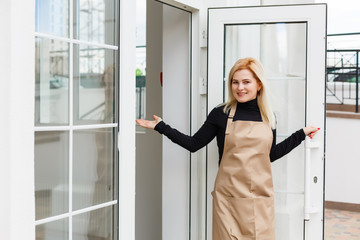 Fototapeta na wymiar Half length portrait of waitress dressed in apron with copy space for brand name open store starting work ready to serve visitors, woman entrepreneur barista standing at restaurant entrance