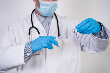 doctor man holding an injection and vaccine tube. Medical concept