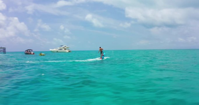 Man riding jet surf board in ocean