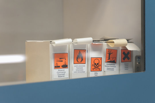 labels with danger signs in a laboratory's showcase