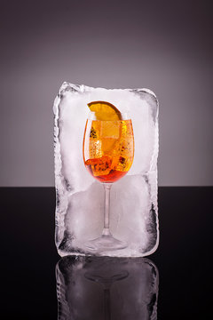 Glass of alcoholic long drink in big ice cube