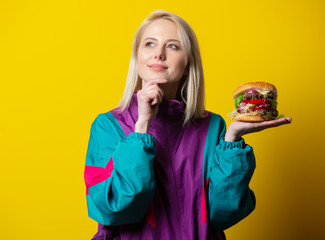 Girl in 80s clothes style with burger