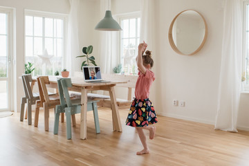girl dancing on a video call with a nurse working in a hospital