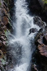 Rocky mountains waterfall in the afternoon short exposure flash