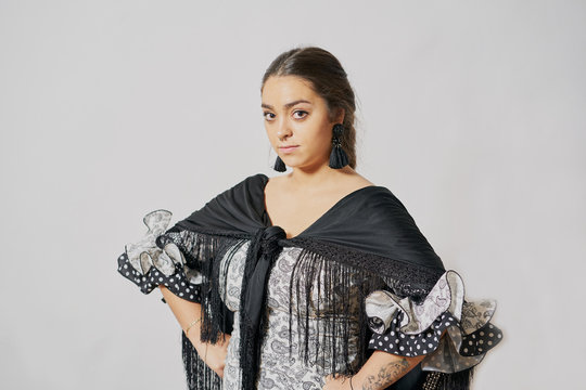 Young Woman Dancing Flamenco On Black