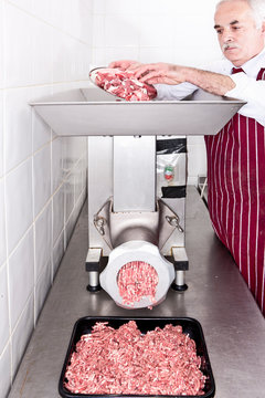 Butcher Grinding Meat In Shop