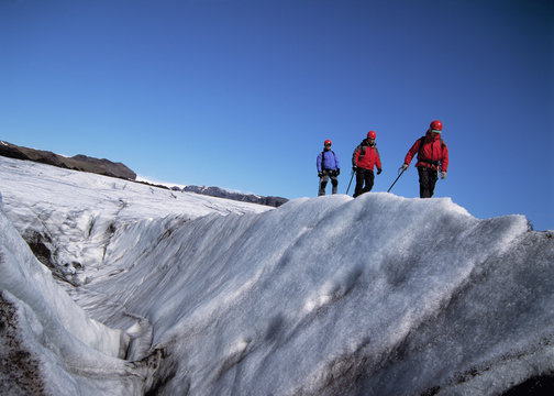 3 men exploring the glacier Solheimajokull